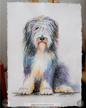 Bearded collie watercolour artwork on an easel showing the deckle edges of the handmade paper.