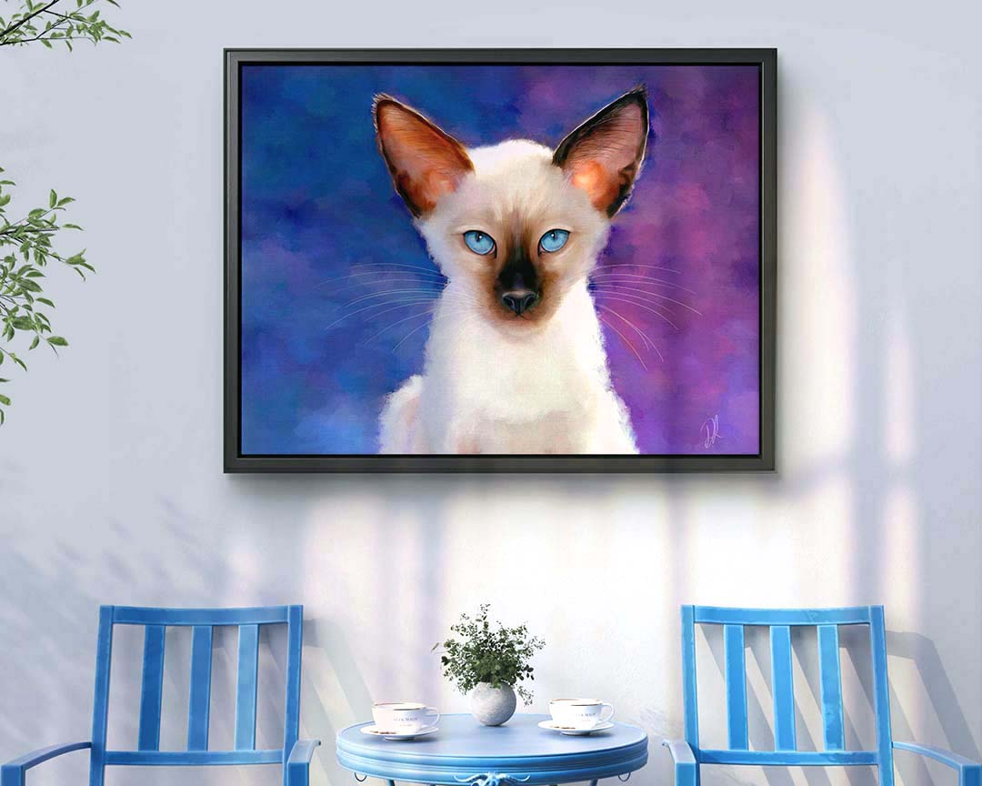 A Siamese cat framed canvas displayed in a stylish setting with blue chairs and a table. The canvas adds blues and purples to the room, enhancing the home decor.