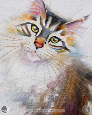 Close up of a tabby cat watercolor painting showing her gold whiskers and expressive yellow eyes. Her ruff has an almost sculpted look, thanks to a bit of experimentation with the handmade paper.