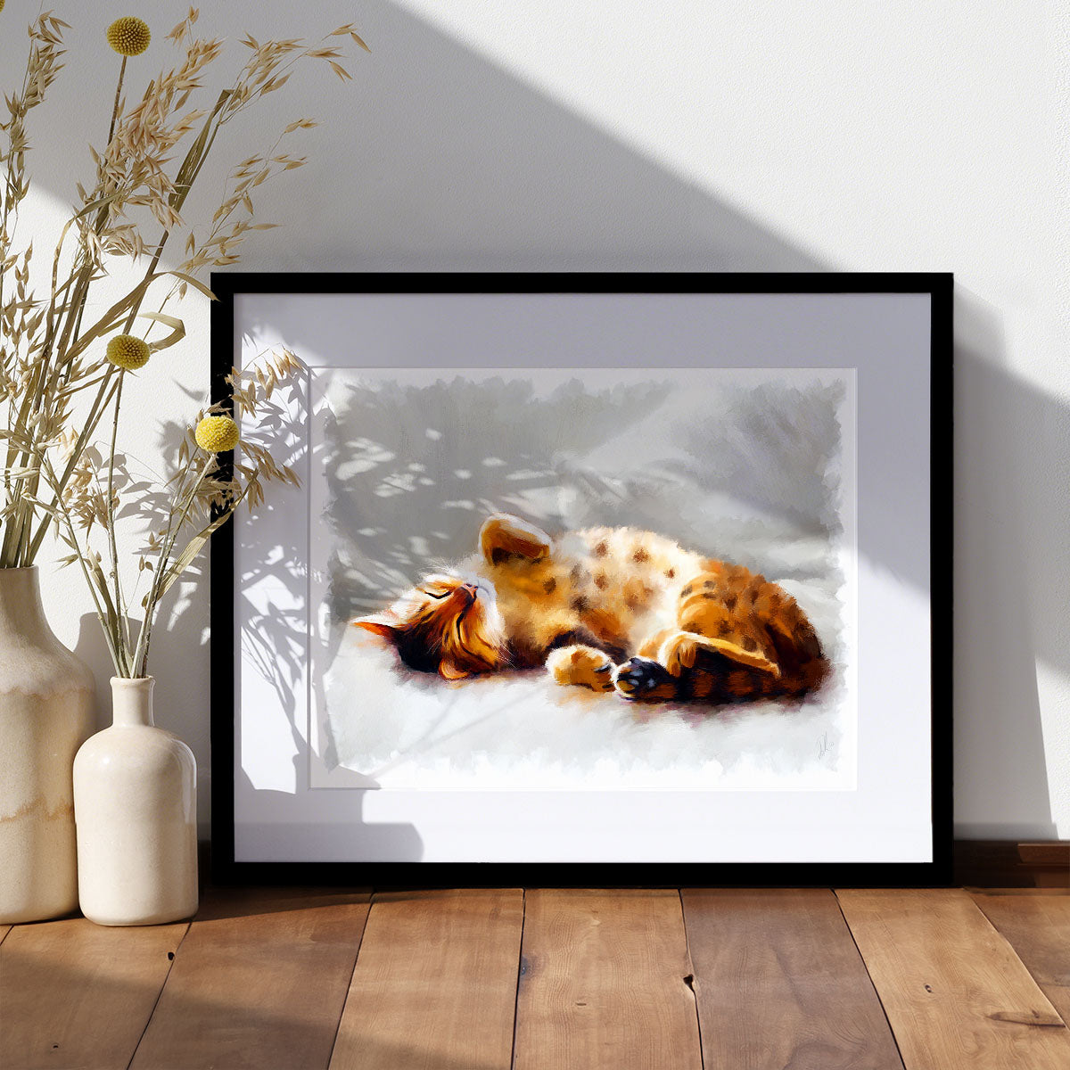 All Curled Up - Bengal Cat Art Print displayed in a stylish frame, showcasing a peaceful Bengal cat lounging on a sofa, ideal for home decor.