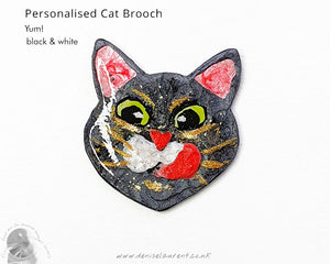 Custom cat brooch featuring a black and white kitty with a playful expression, ideal for those who adore cats.