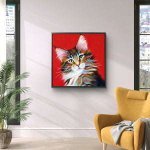 A framed tabby Maine Coon cat canvas hanging in a modern city apartment. The bold red background adds a splash of colour to the home decor.