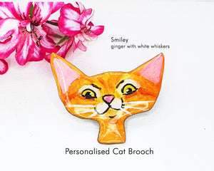 Custom cat brooch illustrating a joyful ginger cat with white whiskers, a delightful gift for animal lovers.