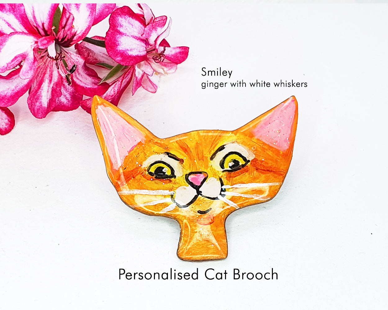 Custom cat brooch illustrating a joyful ginger cat with white whiskers, a delightful gift for animal lovers.