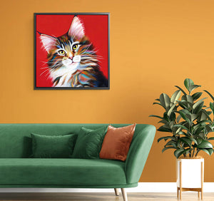 Stylish interior scene showcasing a framed Maine Coon cat canvas above a green sofa, adding charm to home decor.