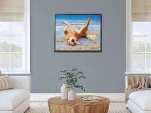 Golden Retriever home decor.  Max is enjoying a sunny day at the beach. The framed canvas hangs in a living room in a modern apartment.