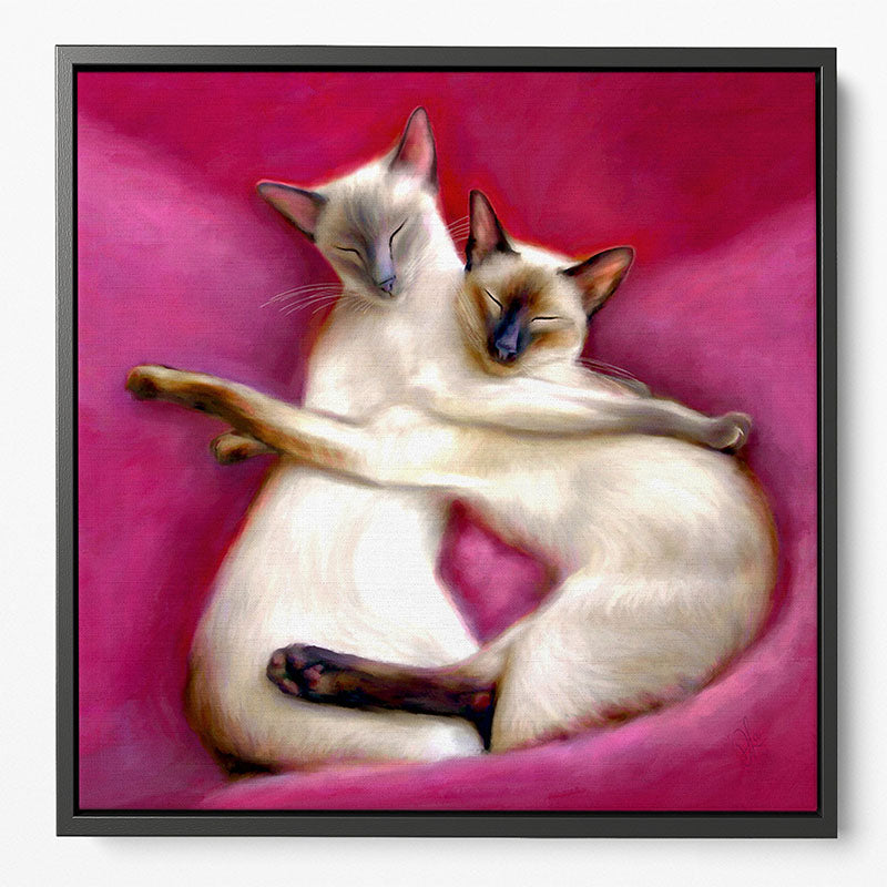 Siamese cat framed canvas, capturing two cats peacefully sleeping together on soft cushions.