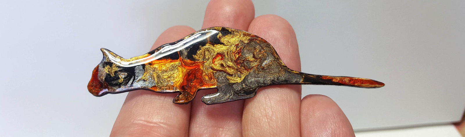 Unique handmade brooch a hazel leaf in blues greens and golds. 