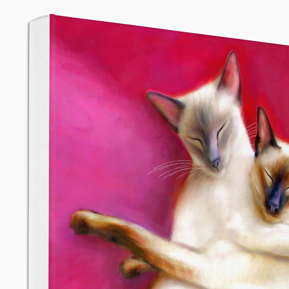 two siamese cats curled up on pink cushions as a canvas print