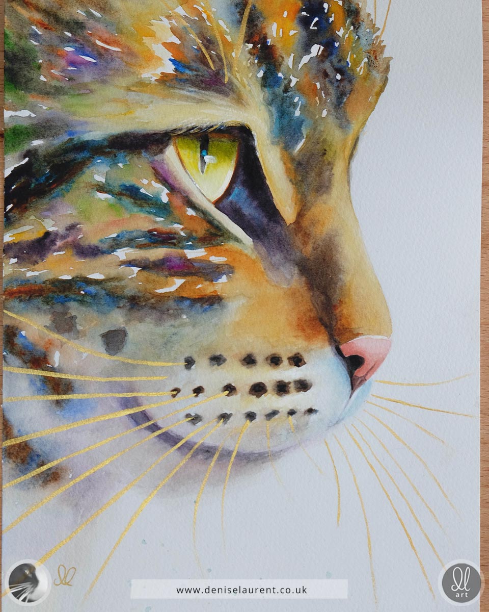 Colorful painting of a tabby cat's face with with gold whiskers by Denise Laurent of The Painted Cat