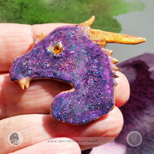 a hand made purple and blue dragon brooch