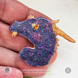 hand made purple blue dragon pin with an orange crystal eye.