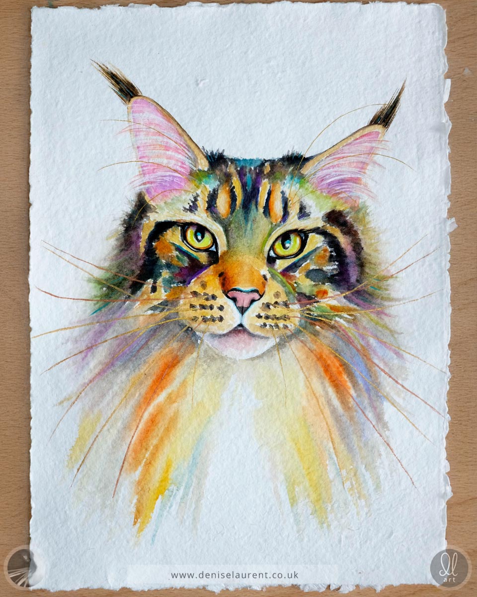 Colorful watercolor painting of a tabby cat's face on textured paper with gold and copper whiskers. Painted on handmade paper with four deckled edges.