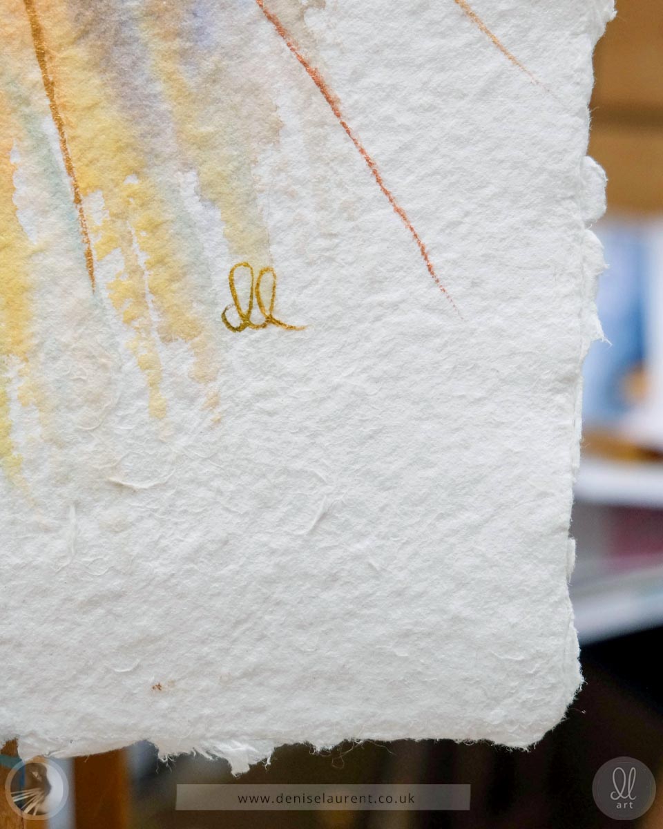 Close up of a watercolor painting on handmade paper showing details of the deckled paper edges, the texture of the paper and the artists signature.