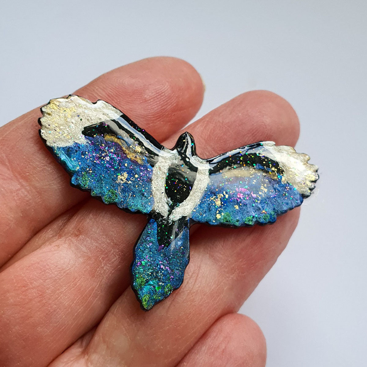 A flying magpie brooch commission, full of sparkle.