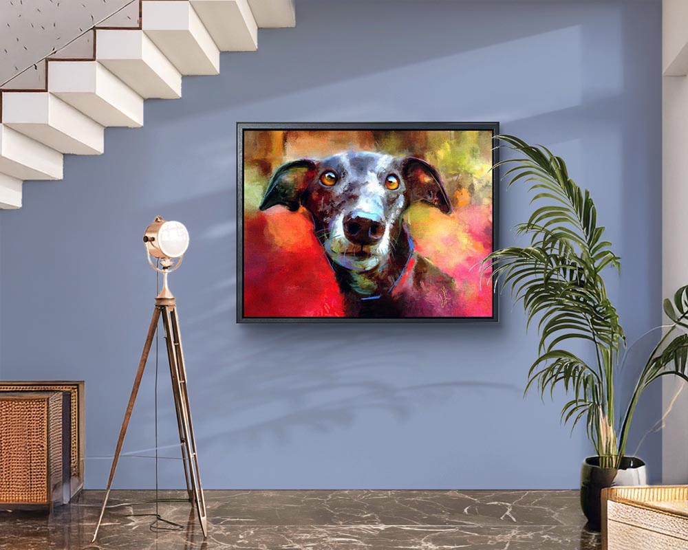 Milly Many Coats - Greyhound wall art. This framed canvas print shows a black greyhound dog with captivating brown eyes against a colourful background of reds and golds.
