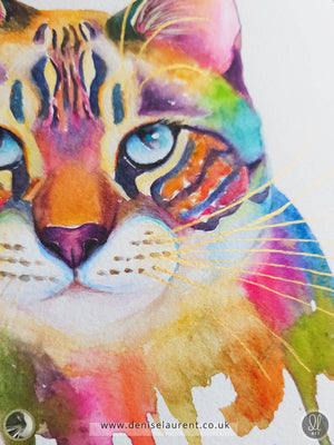close up of a watercolor painting of a colourful cat with gold whiskers.