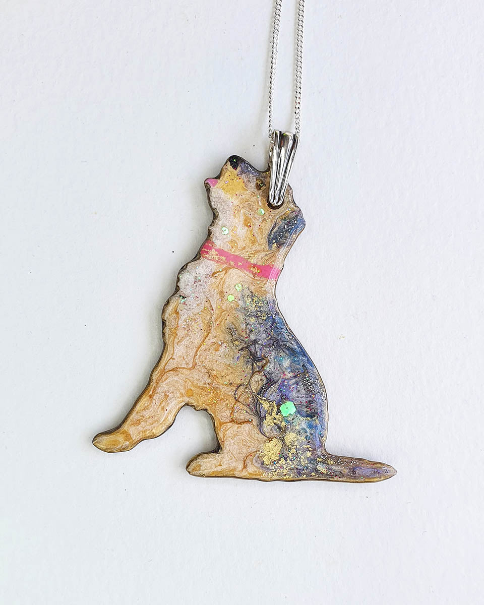Border terrier dog-shaped necklace with a colorful design on a white background