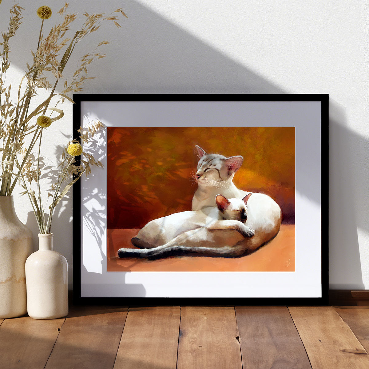 an art print of a siamese cat and kitten curled up on an orange sofa