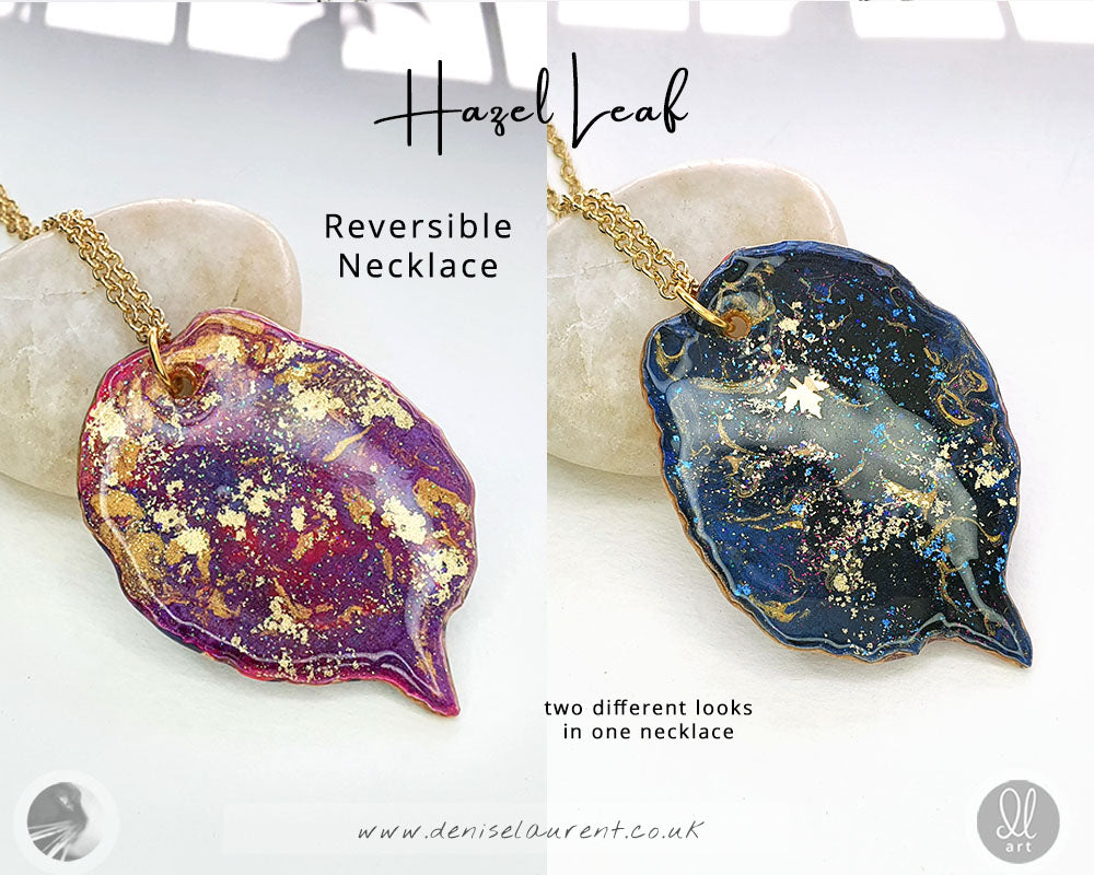 a handcrafted hazel leaf necklace, it has two sides, one side is purples and gold the other side is blue black and gold - like a starry night sky. Two looks in one pendant.