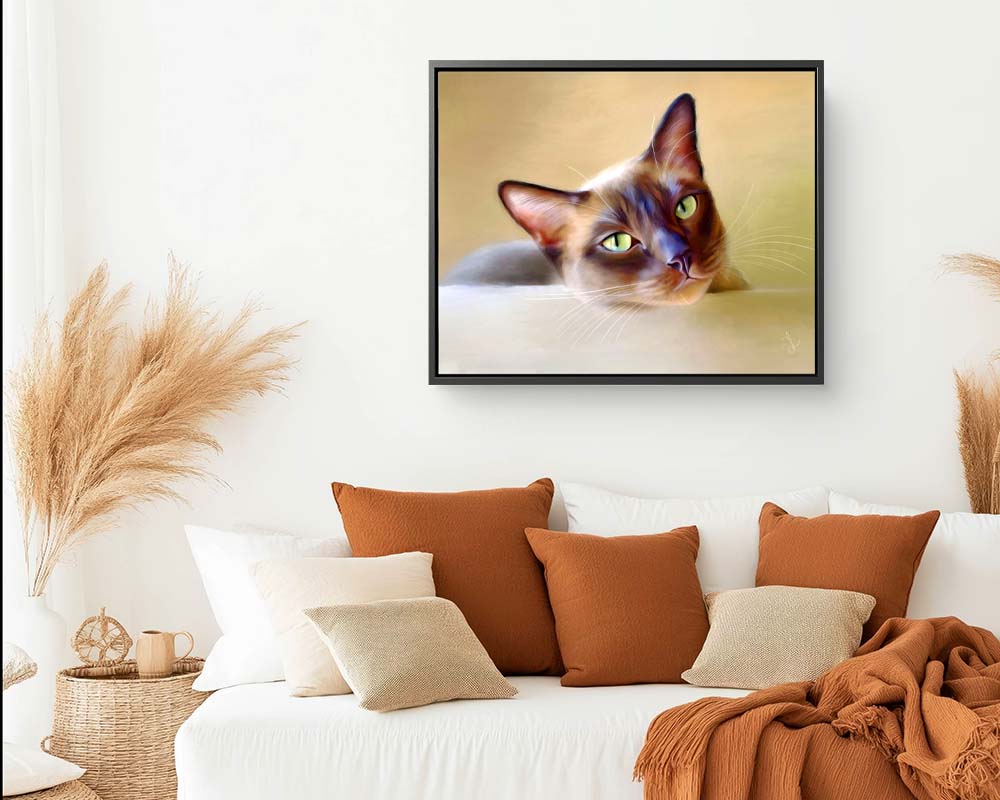 A framed canvas print of a brown cat - a Tonkinese cat with striking green eyes, looking over the stairs at us.