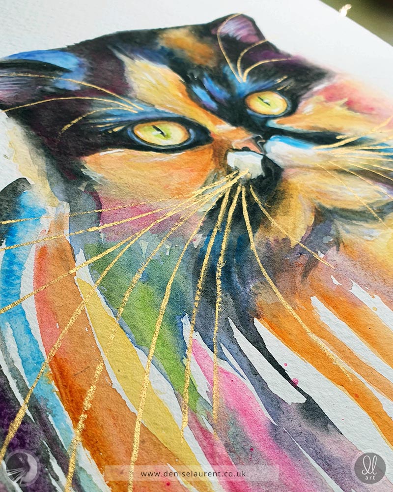 An original watercolour painting of a tortoiseshell cat. She has yellow eyes and her coat is full of colours. The style is impressionistic and the watercolour runs down the page.