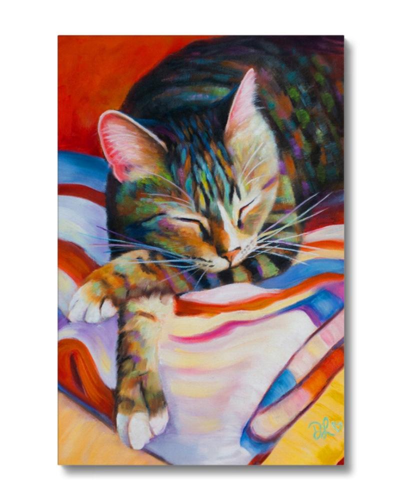 a tabby cat asleep on the laundry