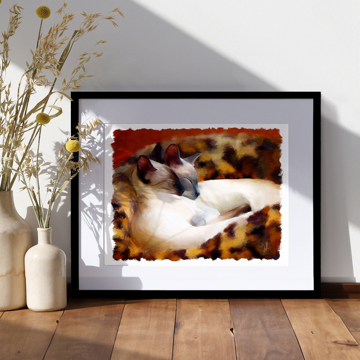 art print of two siamese cats curled in in their basket