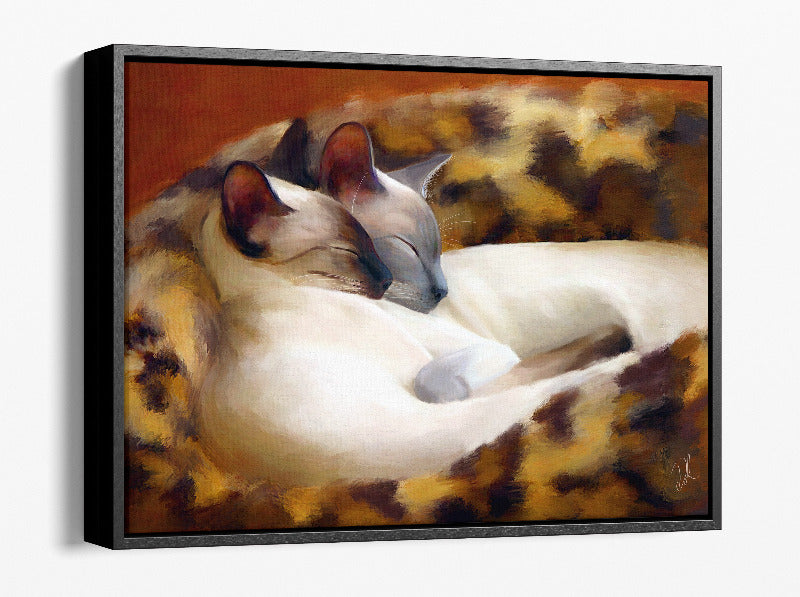 Sleeping Siamese - siamese cat wall art featuring two Siamese cats snuggled together in their cat bed, ideal for adding warmth to any room with this Framed Canvas Print 