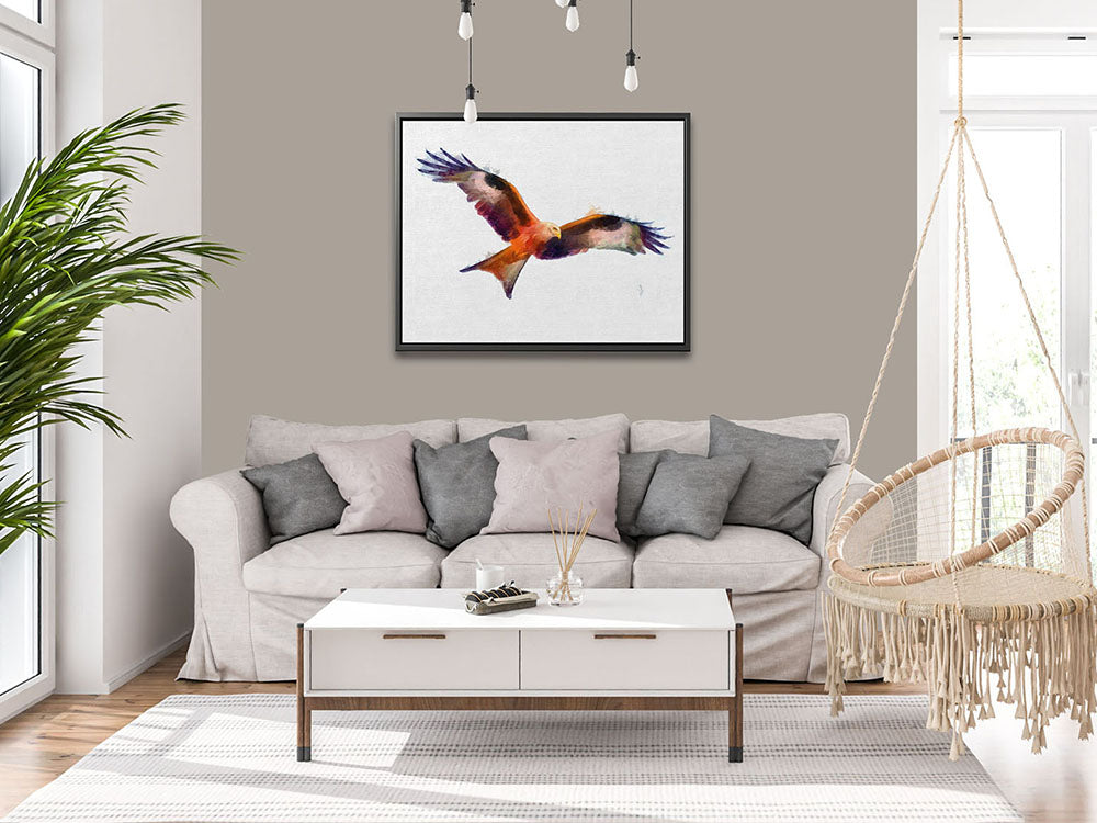 Colourful red kite wall art. A framed canvas print of a red kite in flight, showcasing its beautiful long fingered feathers against a white background, elegantly framed.
